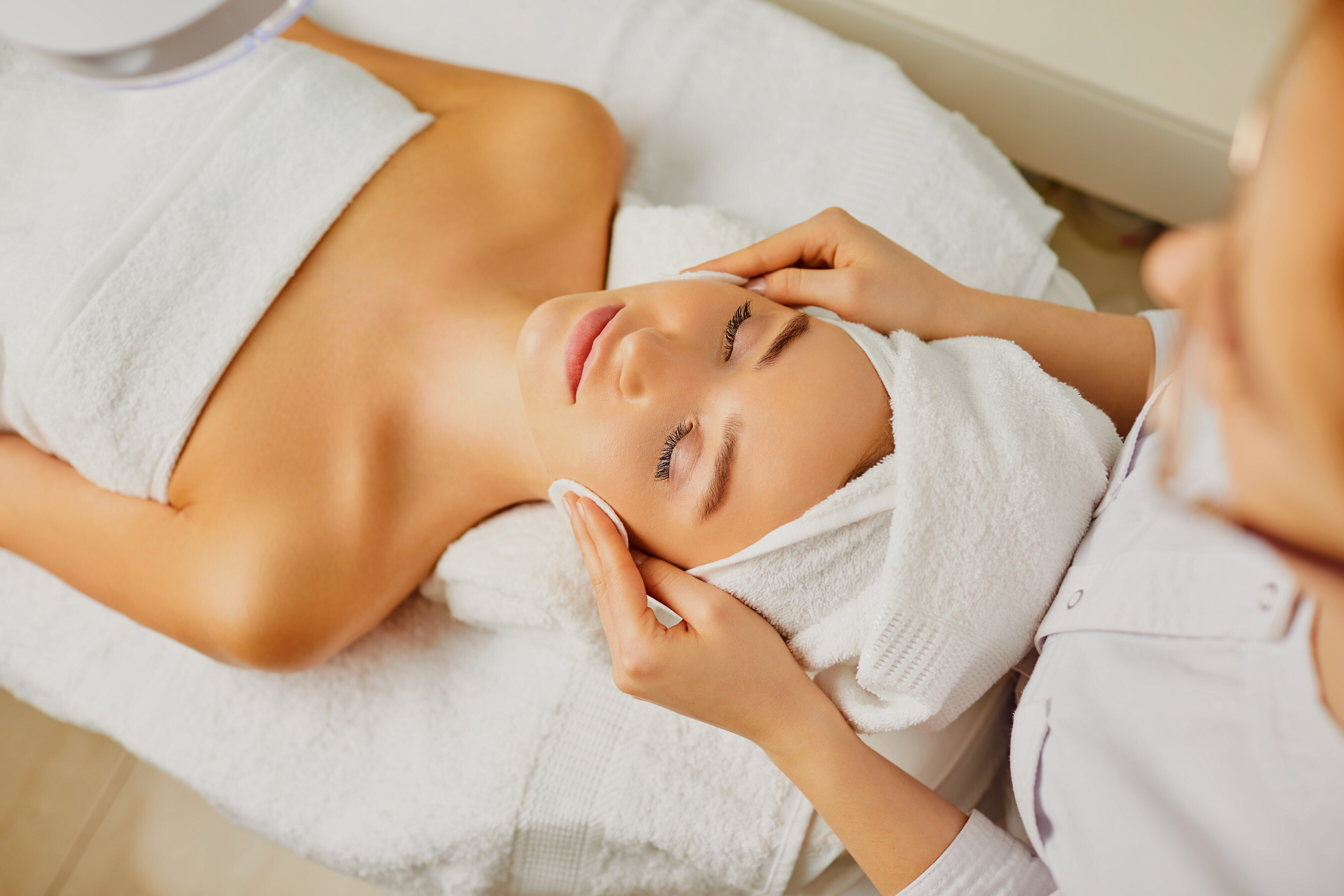 Young Woman Is Cleaned Her Face in a Beauty Salon.